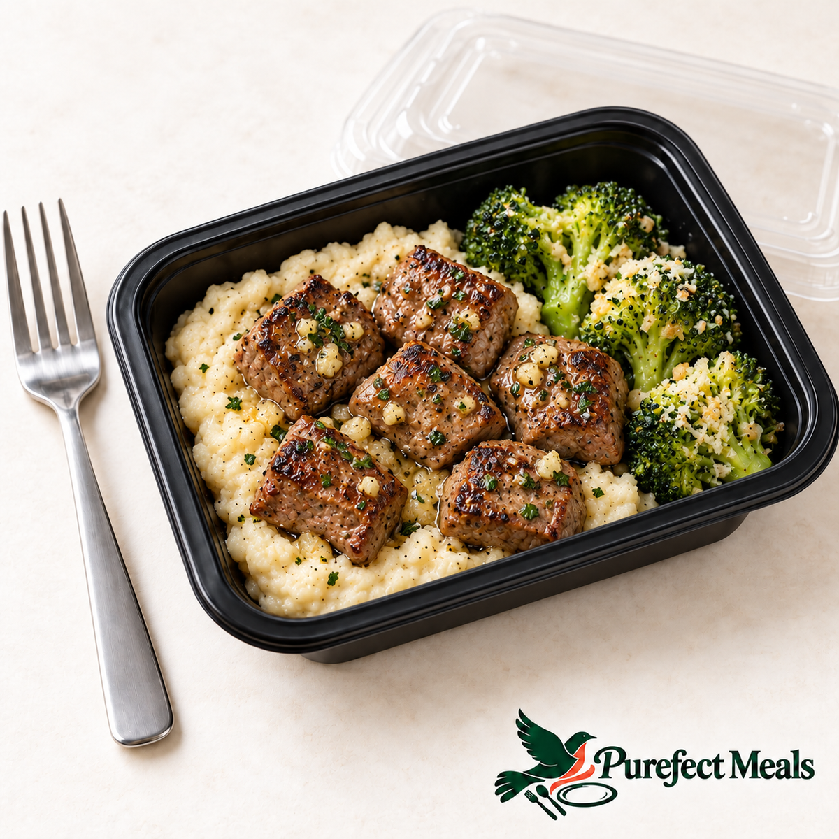 Garlic Butter Steak & Cauliflower Mash in a compact black 12 fl oz grab-and-go container with clear lid and official Purefect Meals logo.