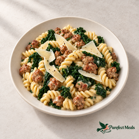 Sausage and kale fusilli with shaved Asiago on a fully visible ivory plate against white.