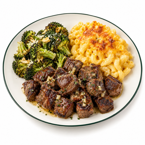 Sous-vide garlic butter steak bites, seared and plated with garlic Parmesan broccoli and Purefect Melt Mac n Cheese (+$2.29 premium upgrade per serving).
