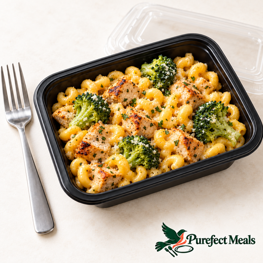 Chicken & Broccoli Mac, served in a compact black grab-and-go tray with a clear lid. AI-generated serving illustration.