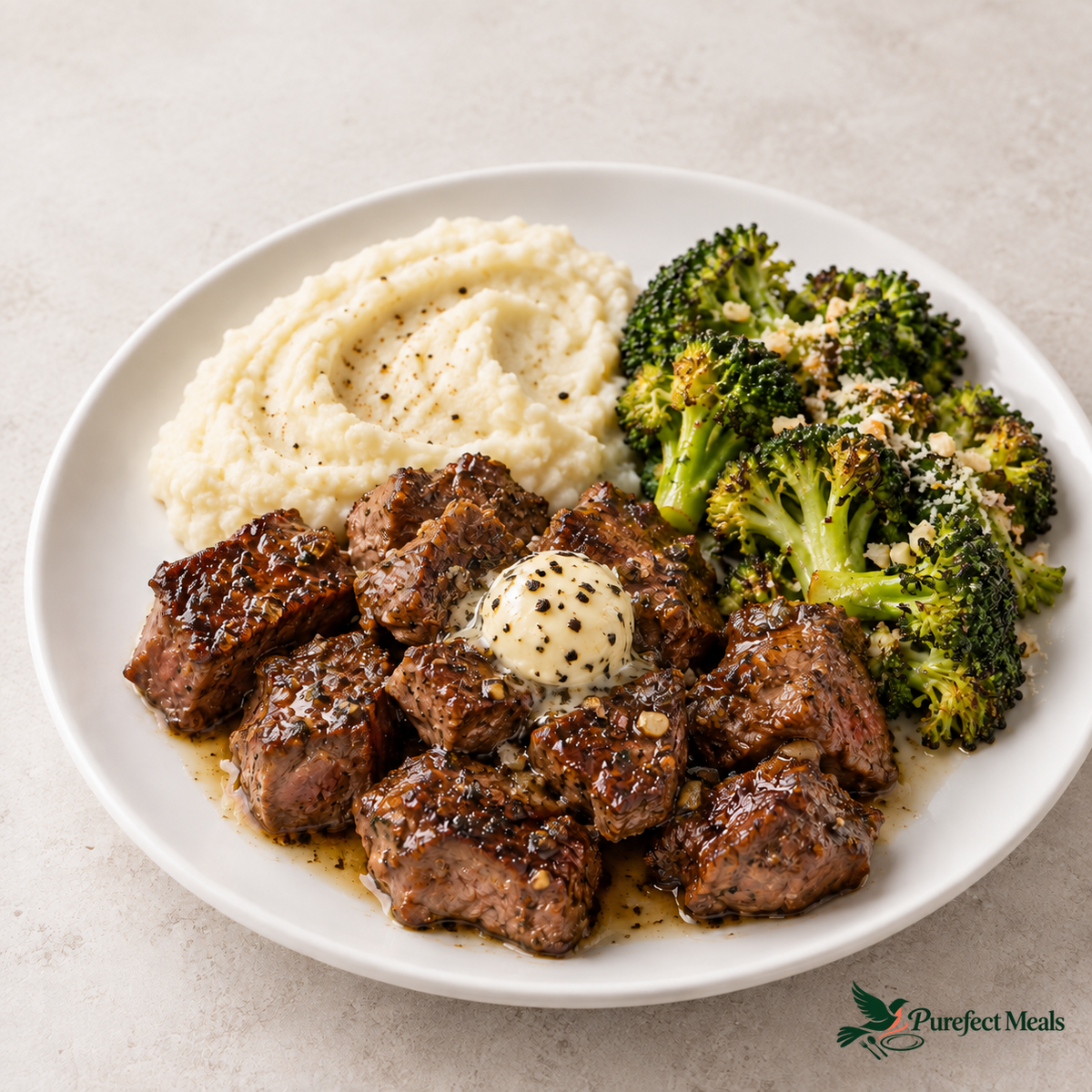 Truffle Butter Steak Bites with a scoop of truffle-salted butter, Cauliflower Mash, and Garlic Parmesan Broccoli. Serving suggestion; choose two sides.