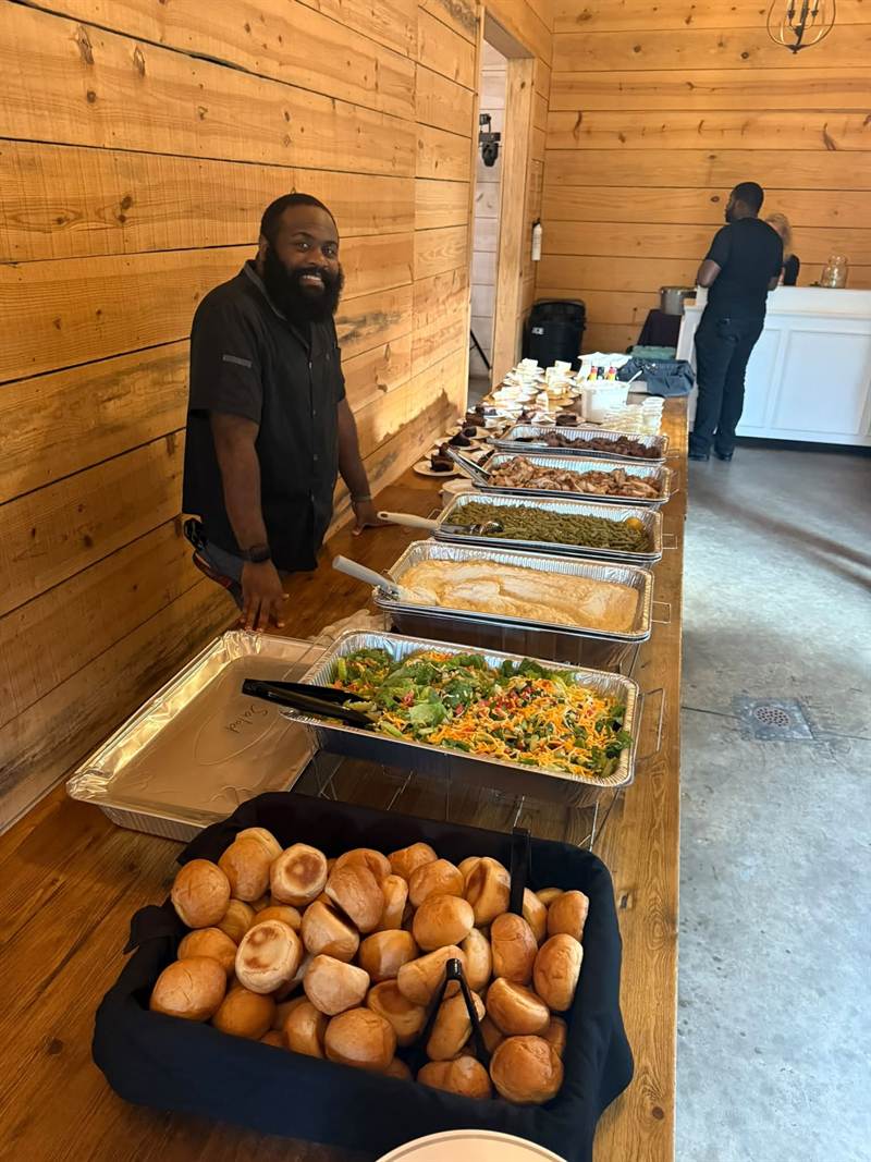 Chef Isaac preparing a catered meal spread